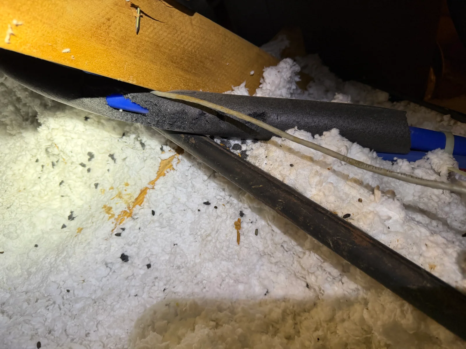 Attic insulation removal showing contaminated fiberglass and cellulose with rodent droppings and debris